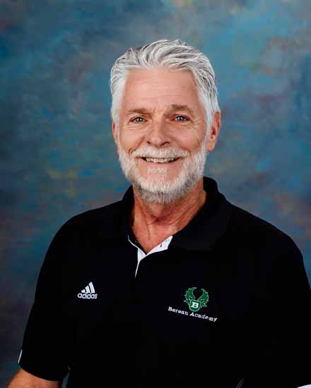 Bryon Lemmon, Berean Academy staff member, wearing a black polo shirt with the school logo and Adidas emblem.